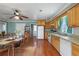 Open kitchen featuring wood cabinets, appliances, and a long dining table at 1155 Casteel Rd, Powder Springs, GA 30127