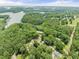 An overhead shot of a lush, green landscape, dotted with scattered homes at 6006 Lanier Heights Cir, Buford, GA 30518