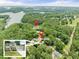 Overhead shot of the lakefront property, featuring a private dock, lake access, and lush greenery at 6006 Lanier Heights Cir, Buford, GA 30518