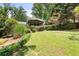 Large backyard with mature trees and partial view of home at 6006 Lanier Heights Cir, Buford, GA 30518