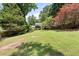 View of home from spacious backyard with mature landscaping and trees at 6006 Lanier Heights Cir, Buford, GA 30518