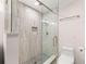 Updated bathroom with glass walk-in shower, tile surround, and neutral vanity at 6006 Lanier Heights Cir, Buford, GA 30518