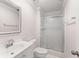 Bathroom with glass sliding door shower, white vanity and countertop and large mirror at 6006 Lanier Heights Cir, Buford, GA 30518