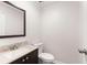Well-lit half bathroom with a stylish vanity and tile backsplash at 6006 Lanier Heights Cir, Buford, GA 30518