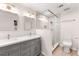Modern bathroom featuring double sink vanity, new lighting, glass shower, and tiled flooring at 6006 Lanier Heights Cir, Buford, GA 30518