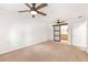 Bright bedroom boasts two ceiling fans, closet, barn door leading to bath, and natural light at 6006 Lanier Heights Cir, Buford, GA 30518