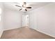 Comfortable bedroom boasts neutral walls, ceiling fan, closet and a doorway leading to another room at 6006 Lanier Heights Cir, Buford, GA 30518