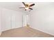 Spacious bedroom featuring a closet, ceiling fan, and neutral decor for a comfortable retreat at 6006 Lanier Heights Cir, Buford, GA 30518