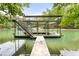 View of covered boat dock with metal structure and stairs leading to the roof of the dock at 6006 Lanier Heights Cir, Buford, GA 30518