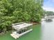 A two-story dock sits in the water, with upper deck furniture, stairs, and access to the lake at 6006 Lanier Heights Cir, Buford, GA 30518