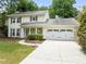 Charming two-story traditional home with a well-maintained lawn and an attached two-car garage at 6006 Lanier Heights Cir, Buford, GA 30518