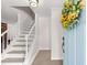 Inviting foyer featuring a staircase, tiled floor, and light blue front door decorated with a floral wreath at 6006 Lanier Heights Cir, Buford, GA 30518