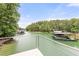 Scenic view of a lake featuring boat docks, lush greenery, and calm waters, creating a serene setting at 6006 Lanier Heights Cir, Buford, GA 30518