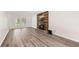 Cozy living room with hardwood floors and a modern wood-accented fireplace at 6006 Lanier Heights Cir, Buford, GA 30518