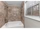 Clean bathroom with tile shower/tub combo and window at 4025 Casa Verde Dr, Atlanta, GA 30349