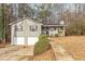 Gray house with two-car garage and a landscaped yard at 4025 Casa Verde Dr, Atlanta, GA 30349