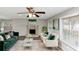 Living room with fireplace, green sofa, and large windows at 4025 Casa Verde Dr, Atlanta, GA 30349