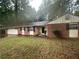 Brick ranch house with attached garage and a spacious yard at 1781 Jajef Ave, Conley, GA 30288