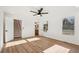 Bright bedroom with wood-look floors, ceiling fan, and access to bathroom at 3939 Hamilton Mill Rd, Buford, GA 30519