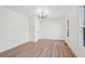 Bright bedroom with wood-look floors, chandelier, and neutral walls at 3939 Hamilton Mill Rd, Buford, GA 30519