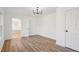 Bright bedroom with wood-look floors, chandelier, and neutral walls at 3939 Hamilton Mill Rd, Buford, GA 30519