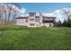 Two-story house back, featuring a deck and a sloped lawn at 3939 Hamilton Mill Rd, Buford, GA 30519