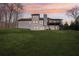 Two story house with deck, beautiful landscaping, and sunset view at 3939 Hamilton Mill Rd, Buford, GA 30519
