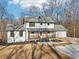 Modern farmhouse with gray roof, wooden porch and attached garage at 3939 Hamilton Mill Rd, Buford, GA 30519