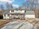 Modern farmhouse with gray roof, wooden porch and attached garage at 3939 Hamilton Mill Rd, Buford, GA 30519