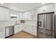 Modern kitchen featuring white cabinets, stainless steel appliances, and quartz countertops at 3939 Hamilton Mill Rd, Buford, GA 30519