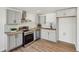 Modern kitchen with gray cabinets, stainless steel appliances, and marble backsplash at 3939 Hamilton Mill Rd, Buford, GA 30519