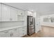 Modern kitchen with white cabinets, stainless steel appliances, and quartz countertops at 3939 Hamilton Mill Rd, Buford, GA 30519