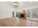 Vaulted ceiling living room with hardwood floors, brick fireplace and access to deck at 3939 Hamilton Mill Rd, Buford, GA 30519
