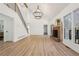 Spacious living room featuring hardwood floors, a brick fireplace, and large windows at 3939 Hamilton Mill Rd, Buford, GA 30519