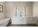 Elegant bathroom featuring a soaking tub, double vanity with modern fixtures, and stylish lighting at 40 12Th Ne St # 1903, Atlanta, GA 30309
