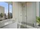 Modern bathroom featuring a glass shower and a large vanity with city views at 40 12Th Ne St # 1903, Atlanta, GA 30309