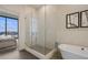 Modern bathroom with a walk-in shower, soaking tub, and access to a spacious bedroom at 40 12Th Ne St # 1903, Atlanta, GA 30309