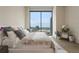 Bright bedroom with a big window and a comfortable bed, complemented by stylish decor and hardwood floors at 40 12Th Ne St # 1903, Atlanta, GA 30309
