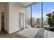 Bright bedroom featuring floor-to-ceiling windows and a king bed with city views at 40 12Th Ne St # 1903, Atlanta, GA 30309