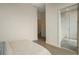 Bright bedroom leading to a bathroom with a frameless shower glass panel at 40 12Th Ne St # 1903, Atlanta, GA 30309