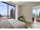 Modern bedroom featuring a large window with stunning city views and stylish decor at 40 12Th Ne St # 1903, Atlanta, GA 30309