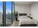 Cozy bedroom with a view of the skyline, natural light, and modern decor at 40 12Th Ne St # 1903, Atlanta, GA 30309