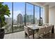Bright dining area boasts floor-to-ceiling windows with expansive city views at 40 12Th Ne St # 1903, Atlanta, GA 30309