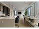 Open kitchen and dining area with modern stainless appliances and dining table at 40 12Th Ne St # 1903, Atlanta, GA 30309