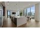 Open-concept kitchen with large island, modern fixtures, and city views at 40 12Th Ne St # 1903, Atlanta, GA 30309