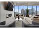 Contemporary living room with fireplace, plush seating, and expansive city skyline views at 40 12Th Ne St # 1903, Atlanta, GA 30309