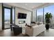 Living room with fireplace, stylish seating, and expansive city views at 40 12Th Ne St # 1903, Atlanta, GA 30309