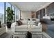 Bright open-concept living space boasts modern kitchen and city views through large windows at 40 12Th Ne St # 1903, Atlanta, GA 30309