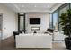 Bright living room with modern fireplace, seating, and city skyline views at 40 12Th Ne St # 1903, Atlanta, GA 30309
