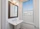 Simple bathroom with pedestal sink and window at 601 Millcroft Blvd, Buford, GA 30518